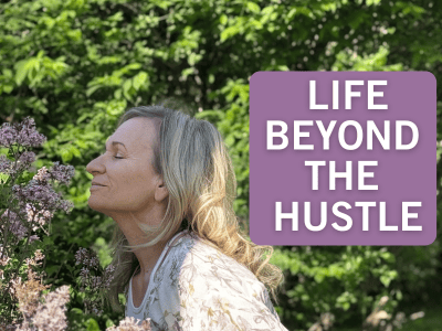 Pretty woman with eyes closed smelling lilac flowers