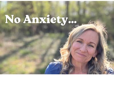 smiling woman with muted forest background