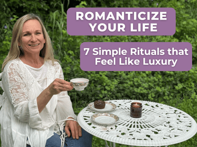 woman having tea outside at white iron table with candle