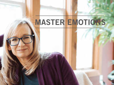 woman with glasses sitting on the couch and smiling