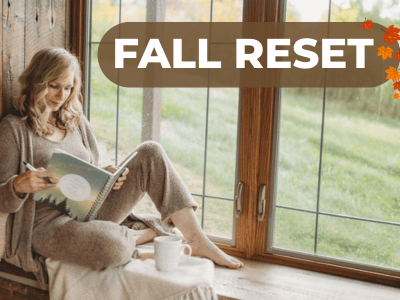 woman reading journal on window ledge