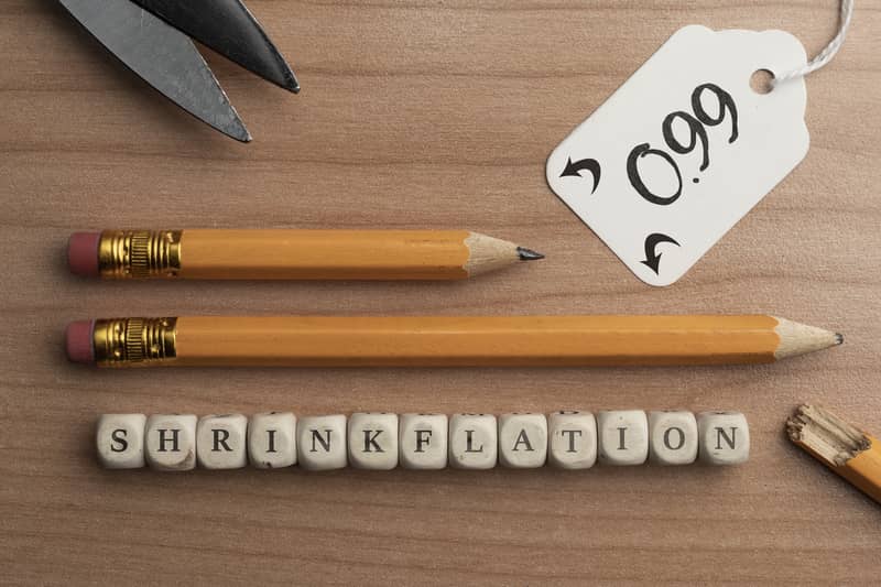 2 sizes of pencils and tiles with the word shrinkflation