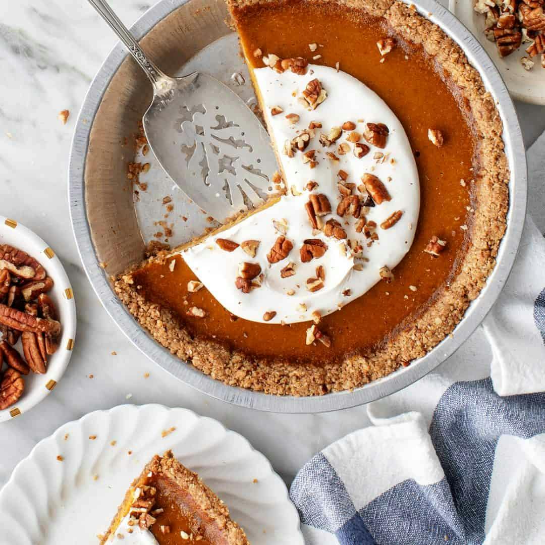 Pumpkin pie with whipped topping and pecan crust