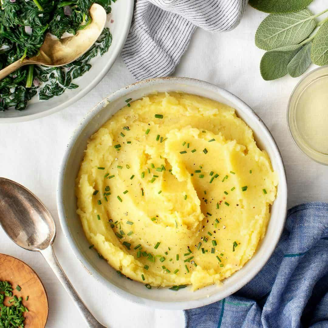 Thanksgiving side dishes on white tablecloth