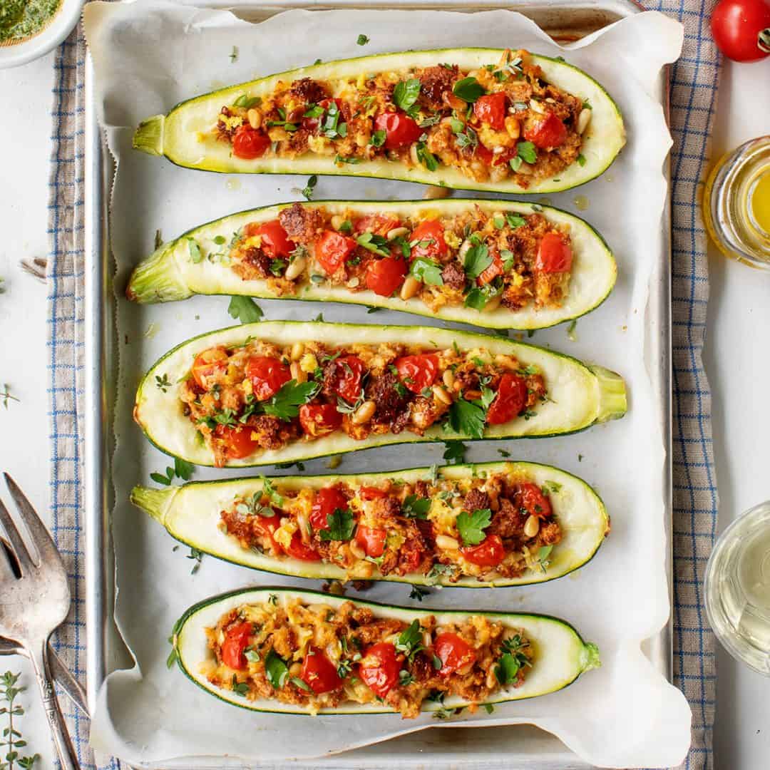 Stuffed zucchini boats on a baking sheet