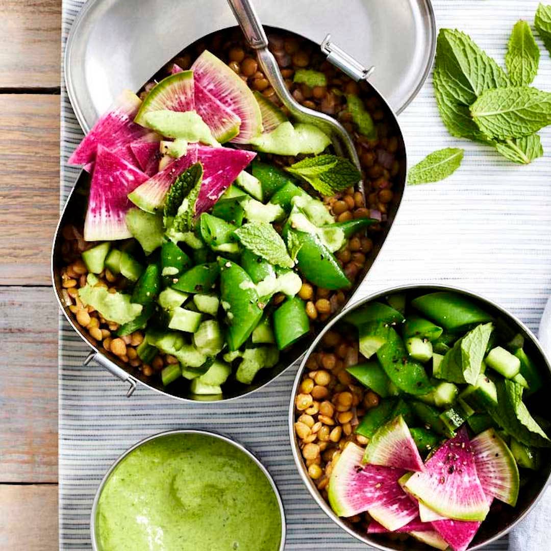 Lentil salad with spring veggies and green tahini in meal prep containers