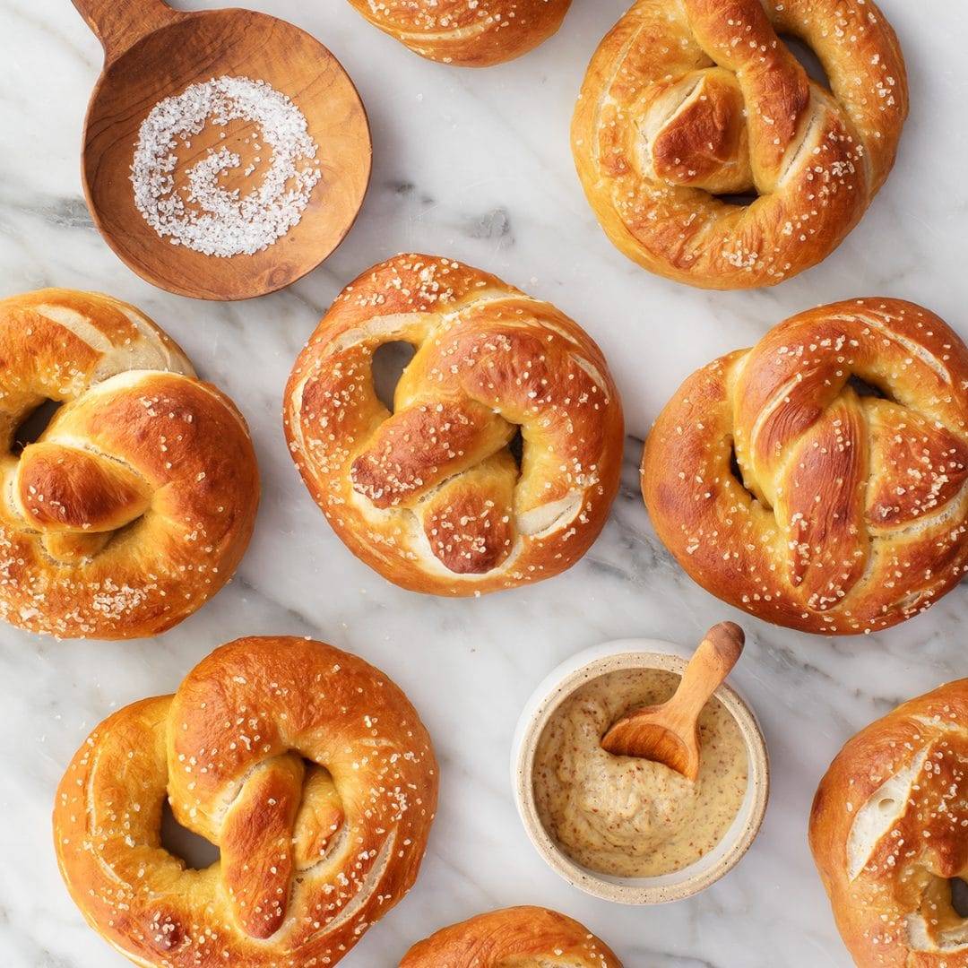 Homemade soft pretzels with small bowl of brown mustard