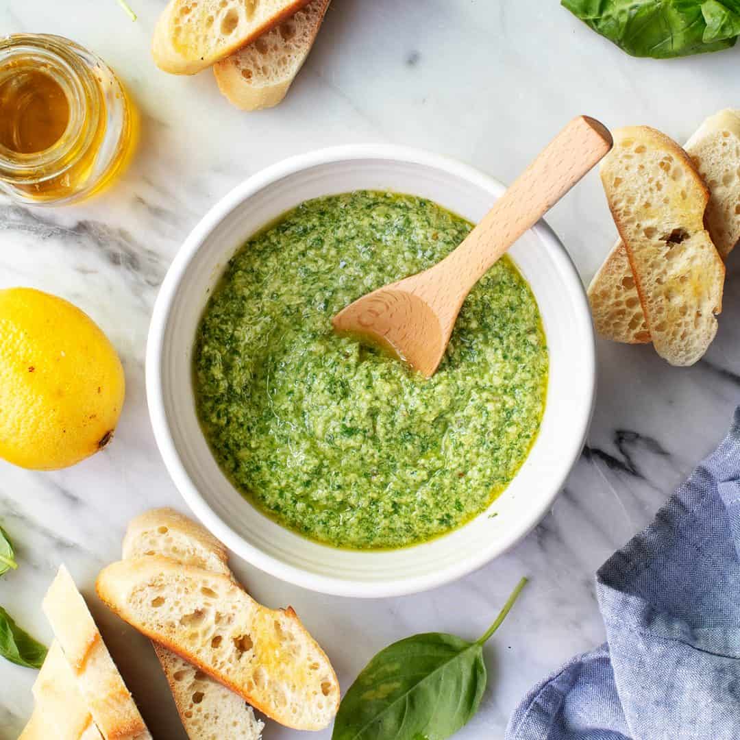 Basil pesto in bowl with spoon
