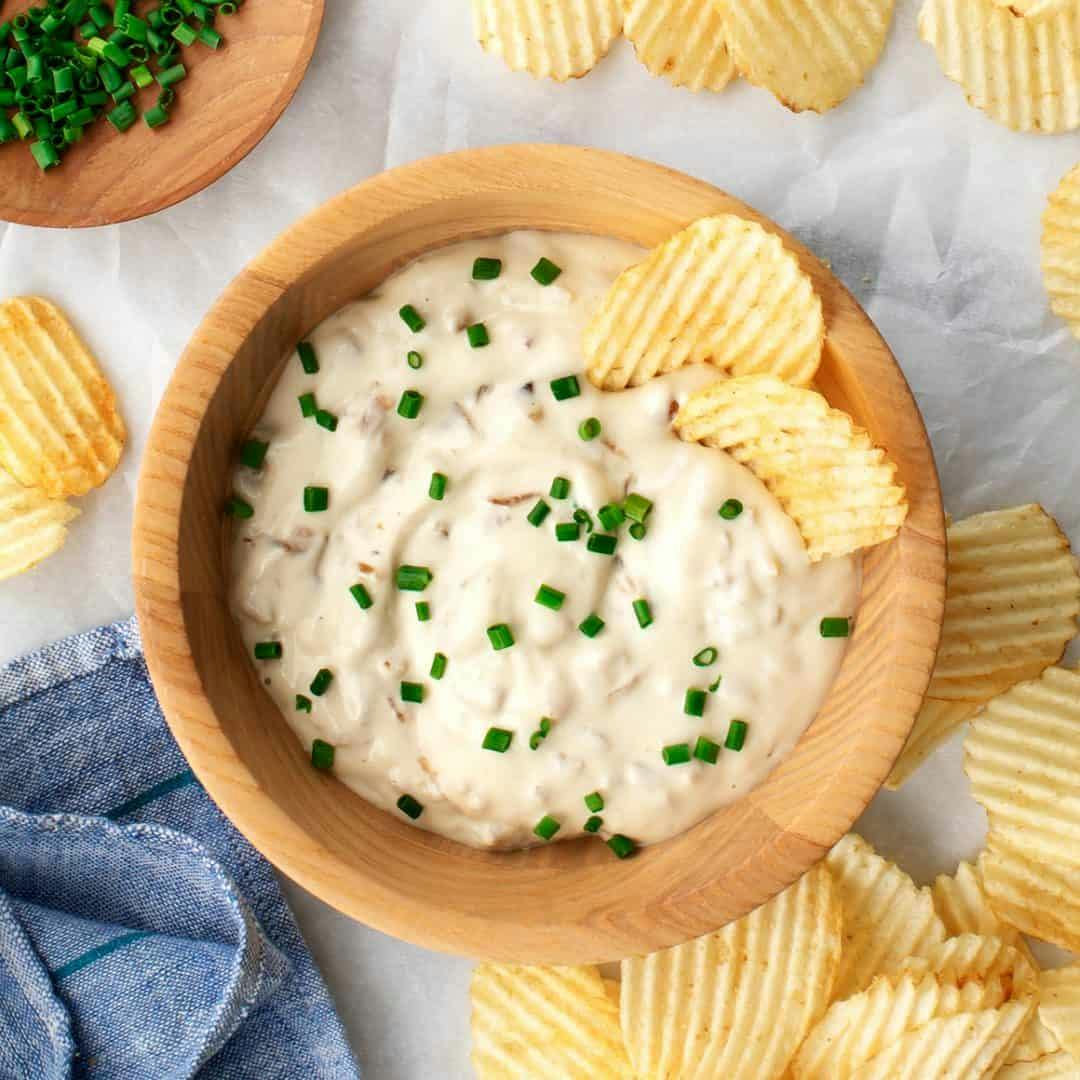 Bowl of French onion dip with ridged potato chips