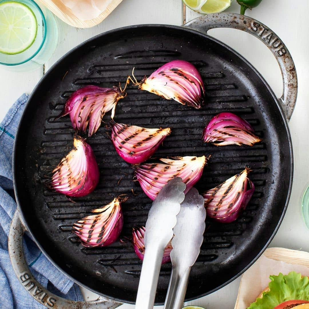 Grilled onion wedges on a grill pan