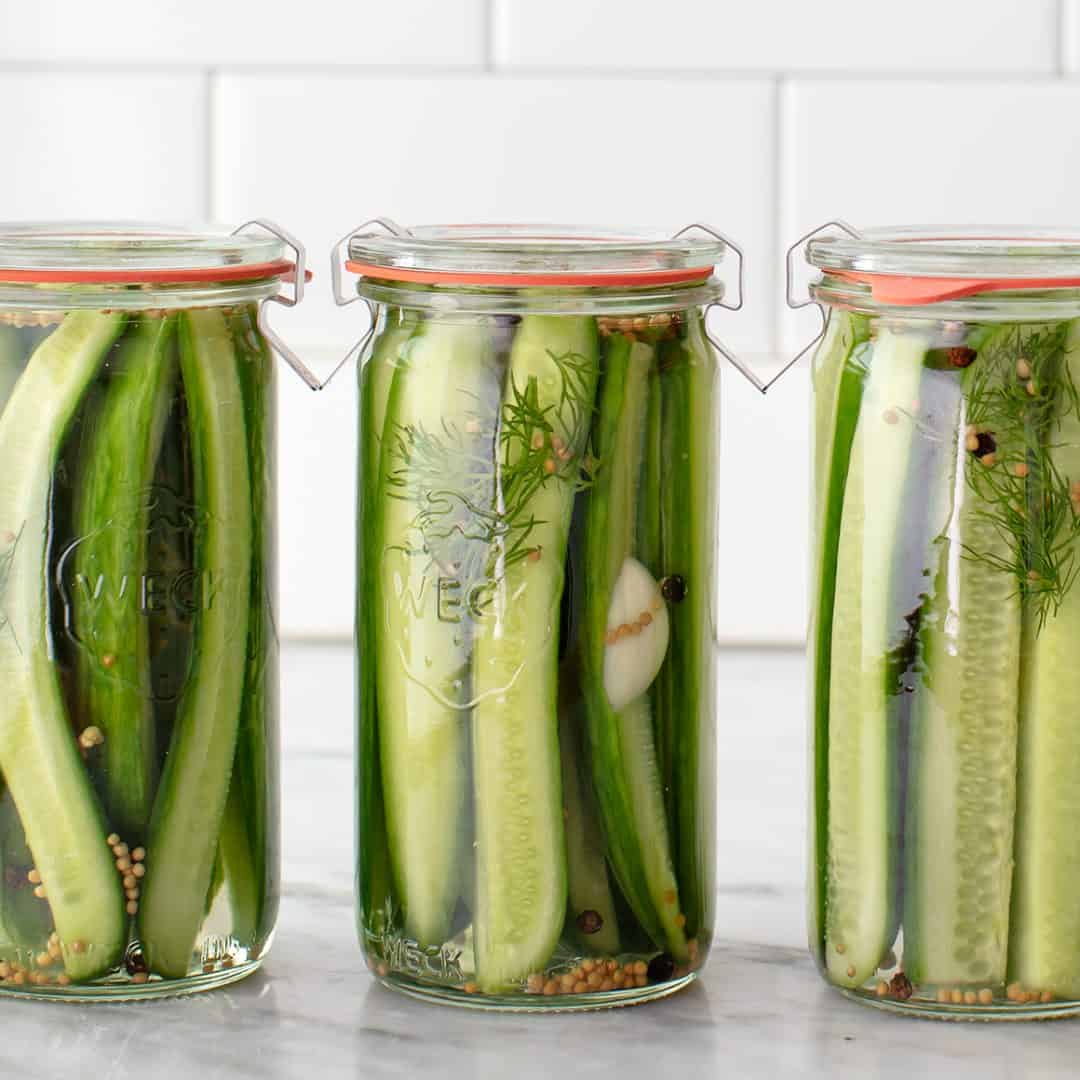 three jars of dill pickles