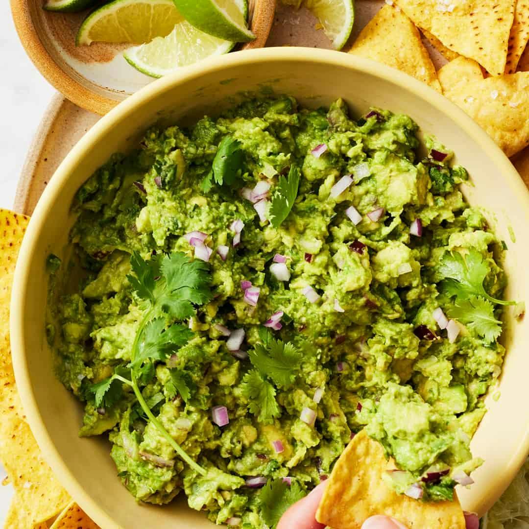 Guacamole topped with red onion and cilantro
