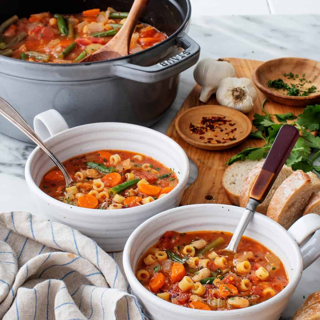 Minestrone soup in two bowls with spoons