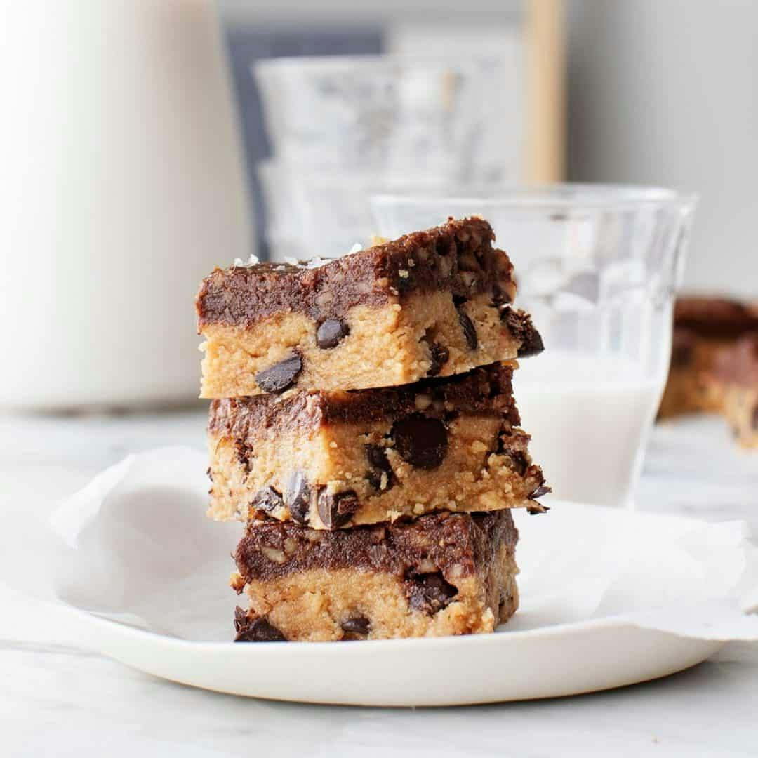 Stack of 3 peanut butter chocolate chip cookie bars on a plate