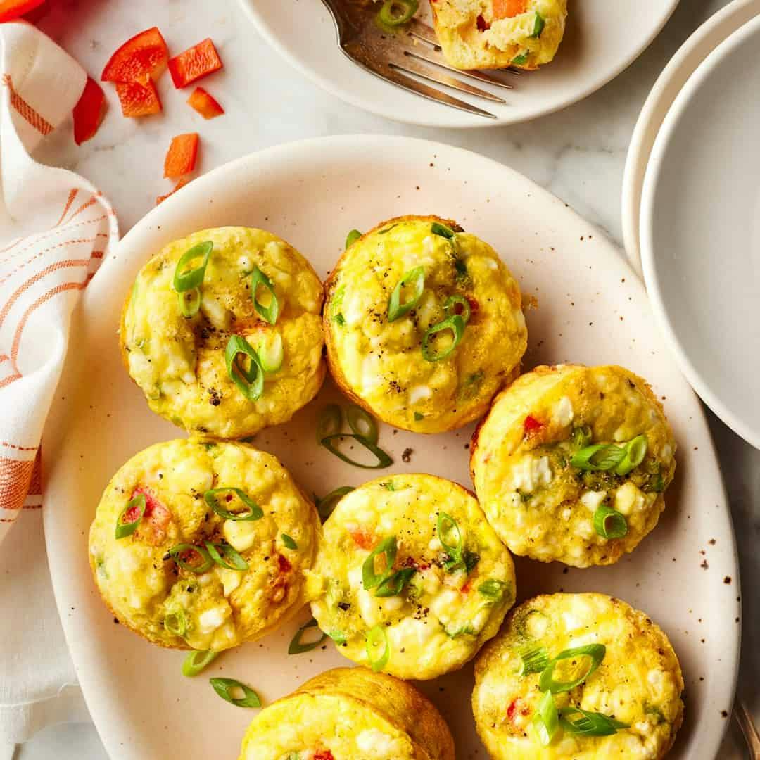 Egg muffins on a plate with chopped scallions