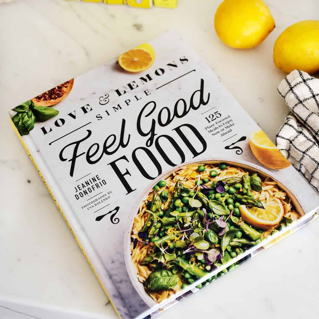 Simple Feel Good Food cookbook on marble countertop