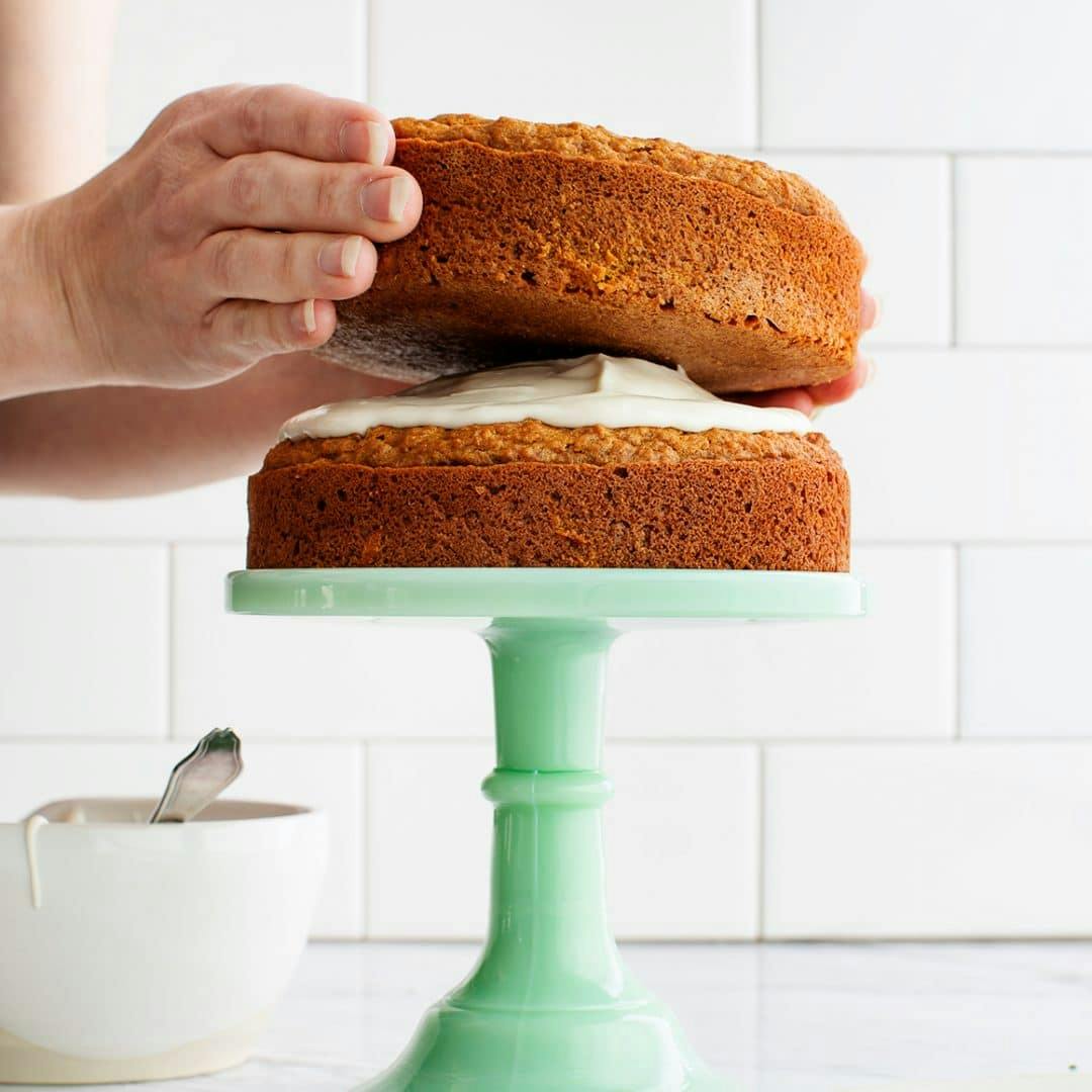 Assembling carrot cake on a cake stand