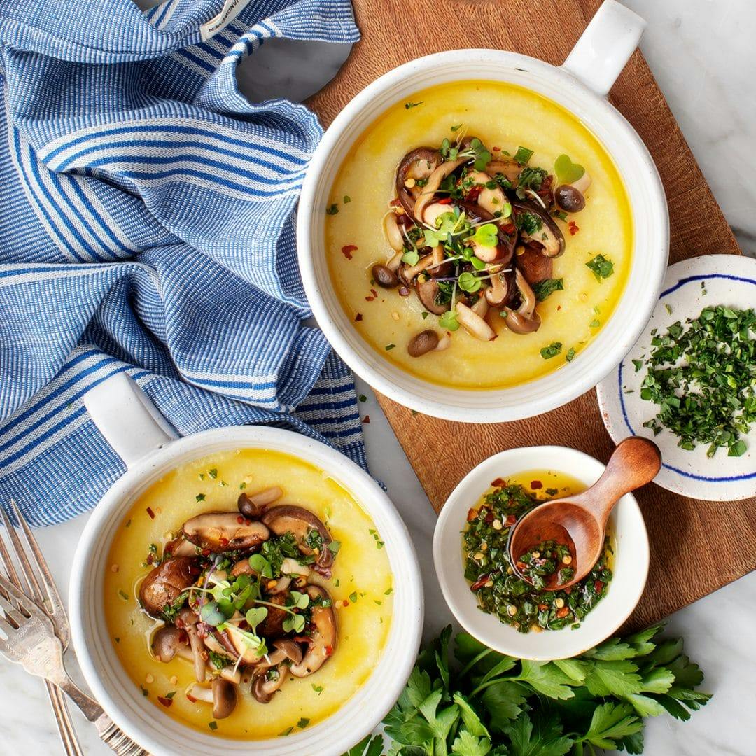 Two bowls of polenta with mushrooms