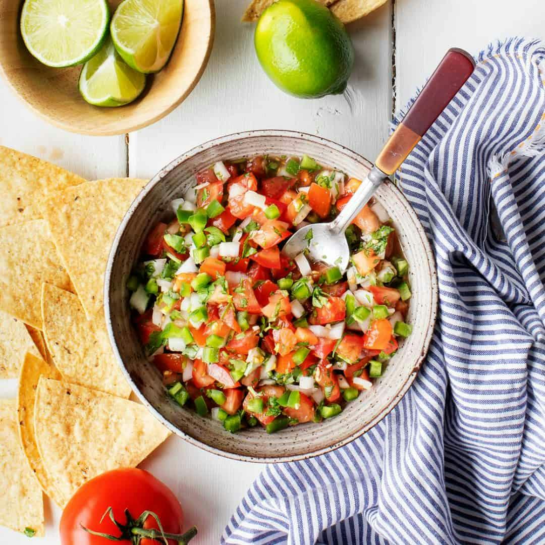 Pico de gallo in bowl with spoon