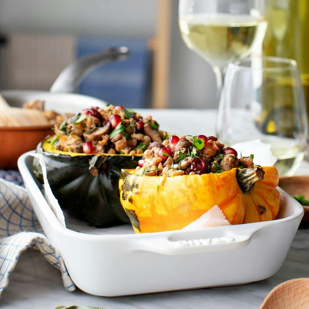 Stuffed acorn squash in a baking dish