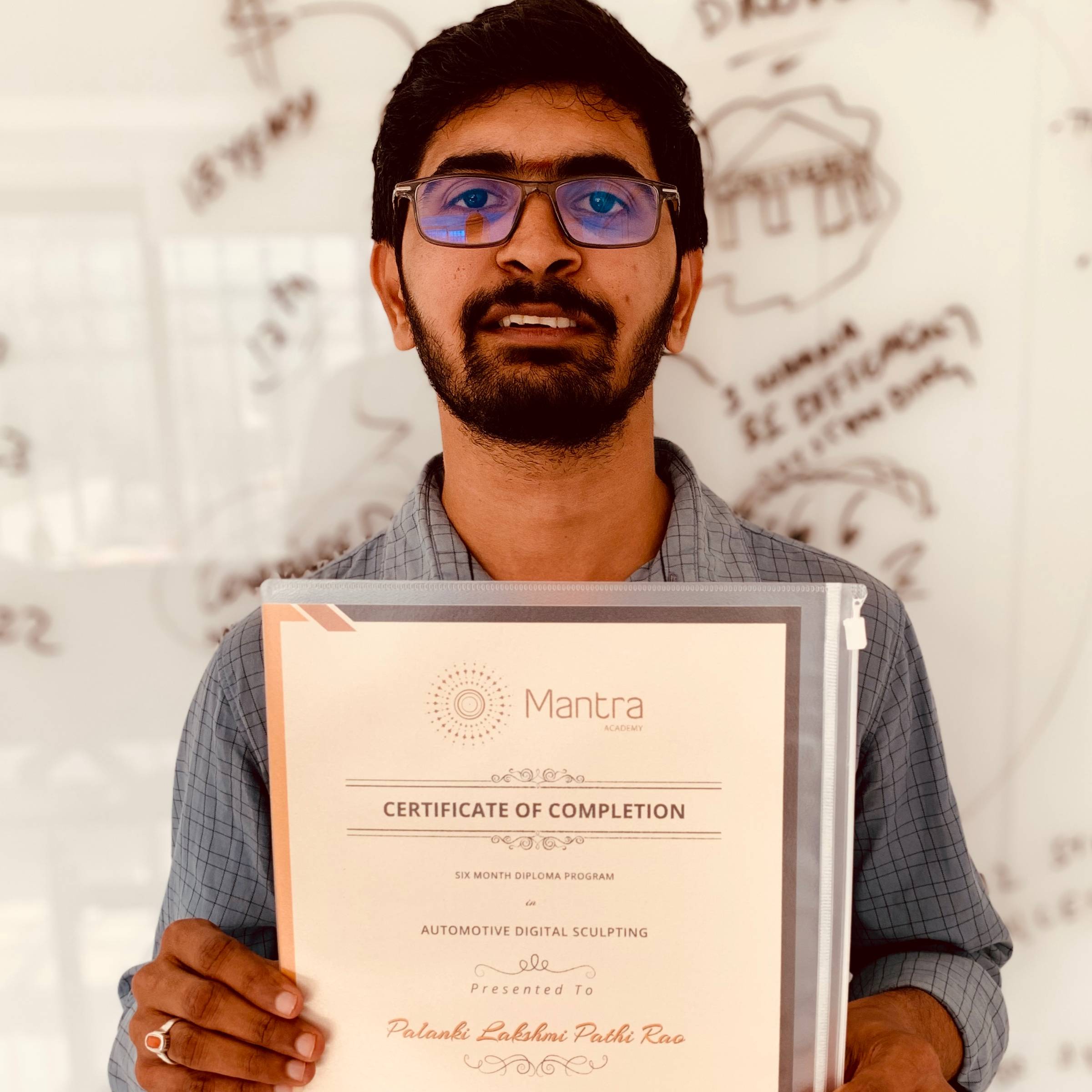 A design student at Mantra Academy, Bangalore, Lakshmi Pathy holding his course completion certificate
