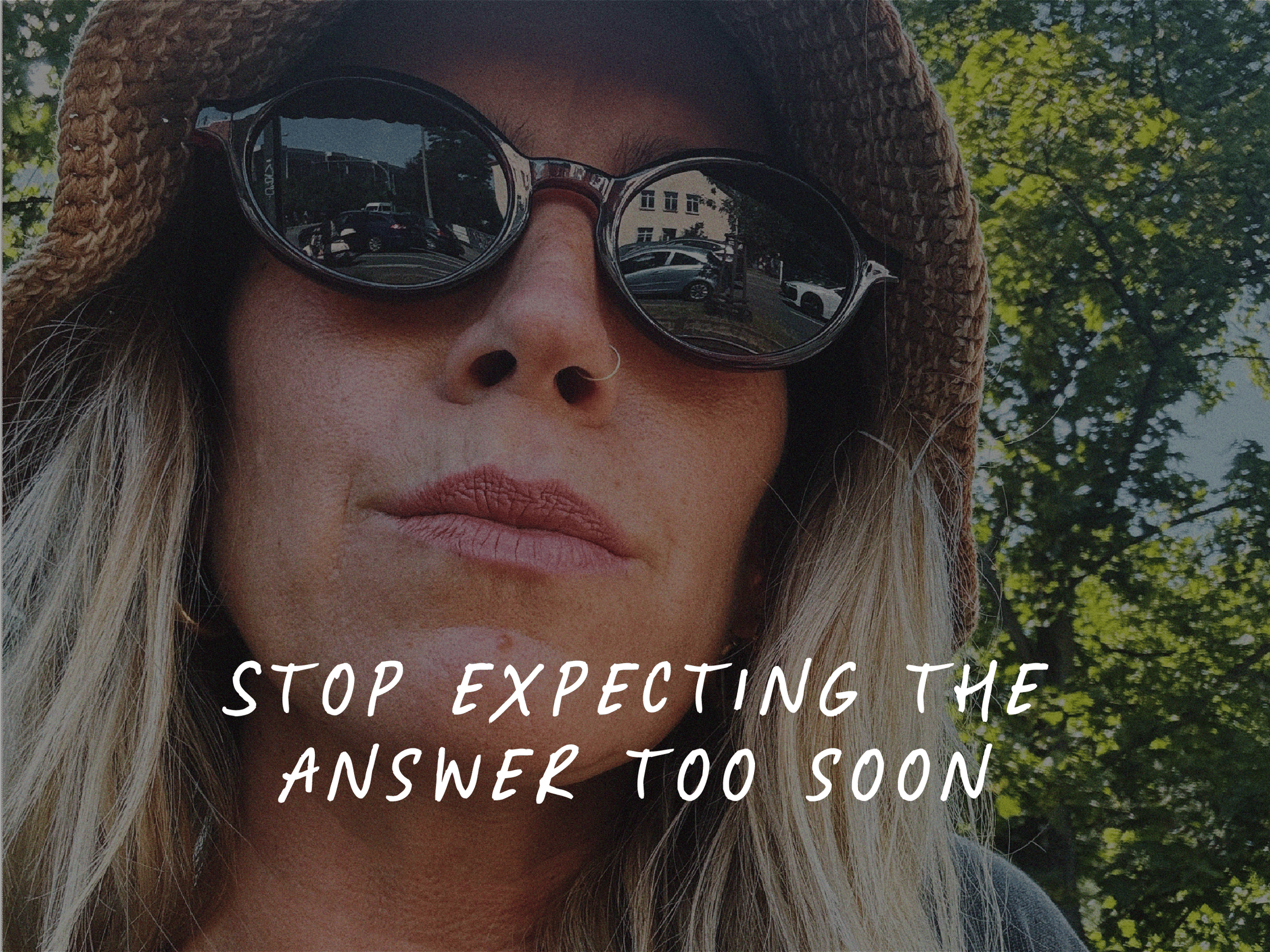 Selfie of a woman wearing sunglasses outdoors in bright sunlight