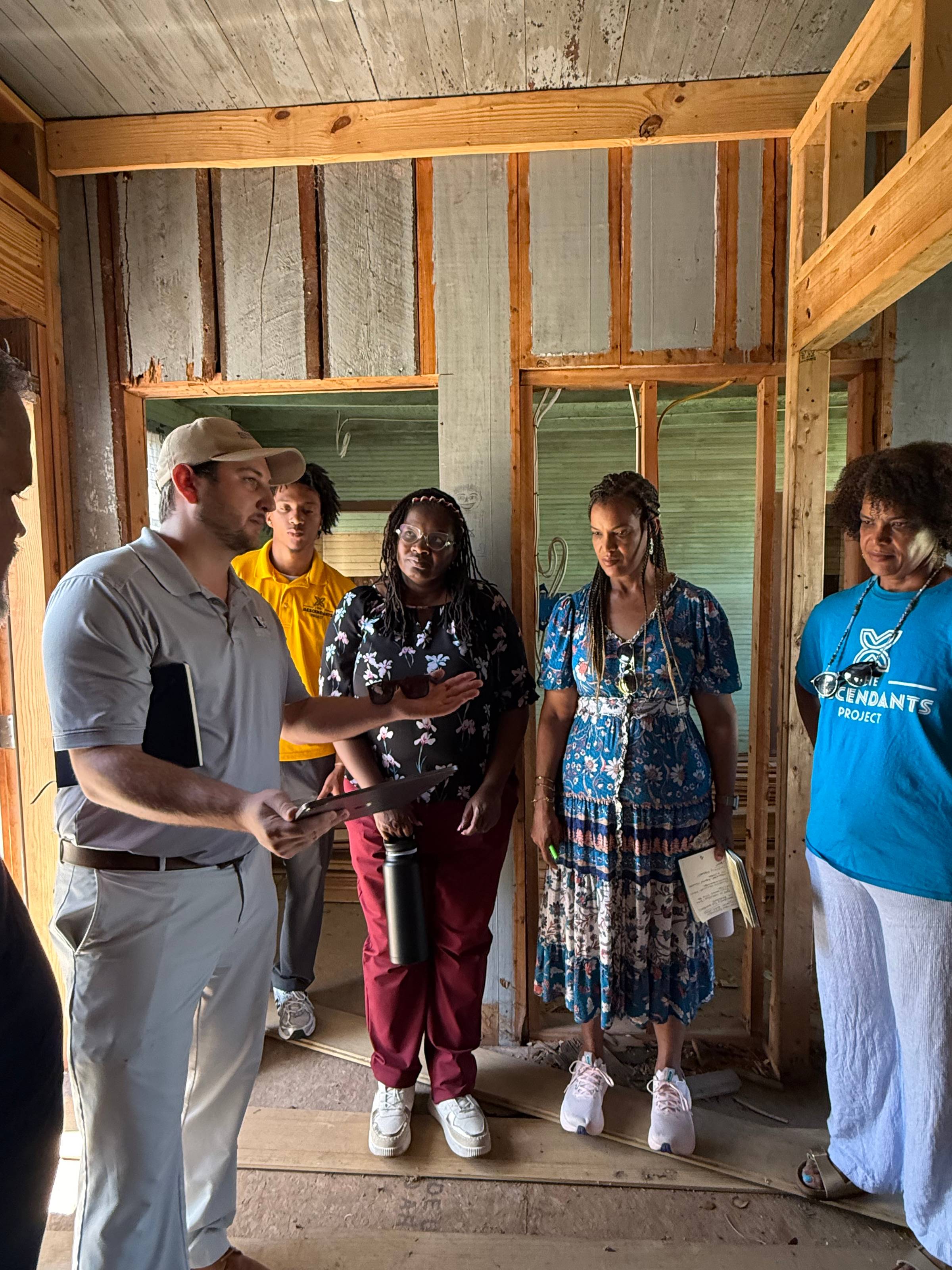 Nick Dubuc, AIA, of Kevin Harris Architect meeting with the team behind The Descendants Project inside the Many Waters house in Wallace, Louisiana
