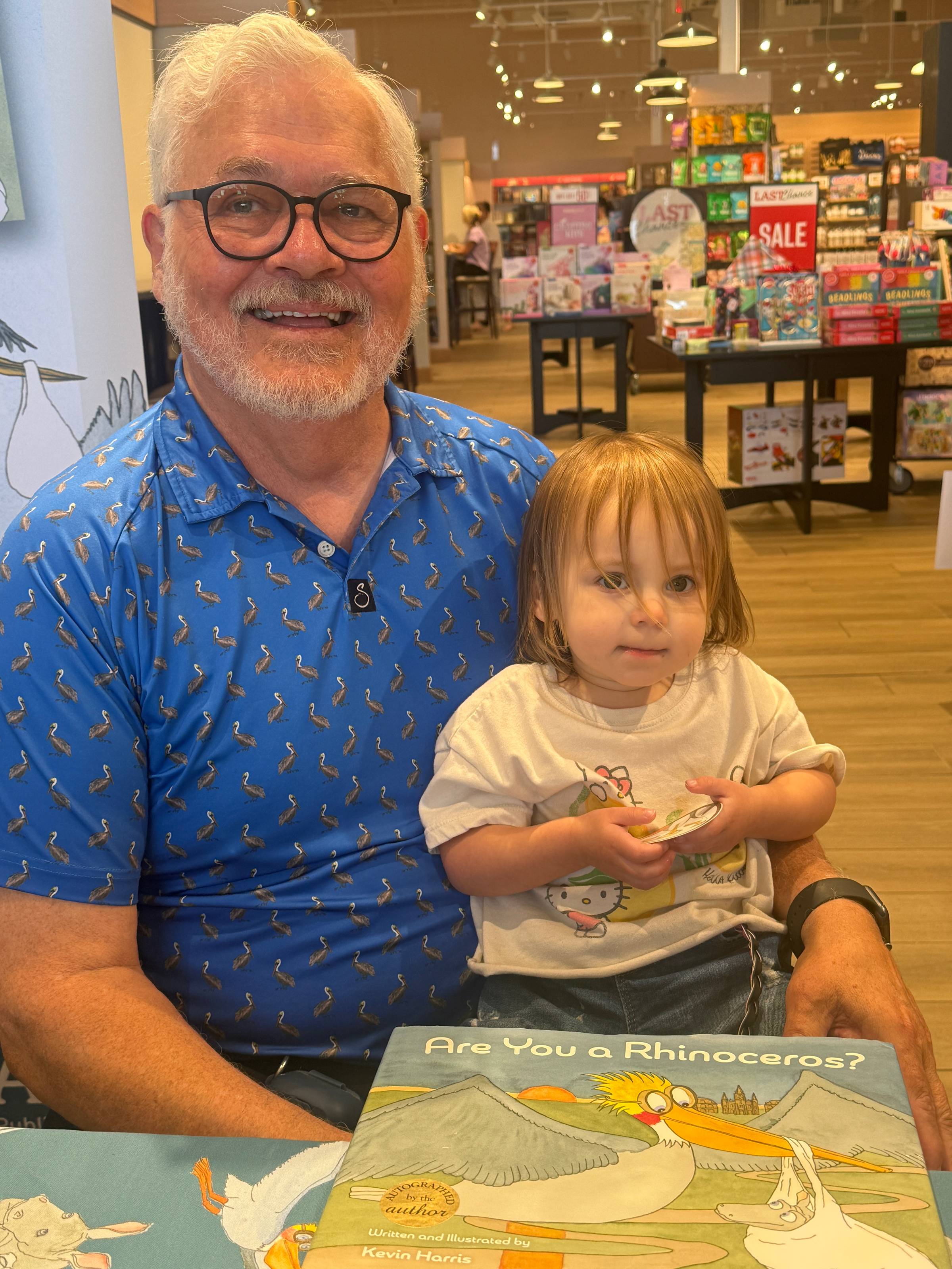 Kevin Harris with a young reader named Lyra at her first book signing, Barnes and Noble in Denham Springs