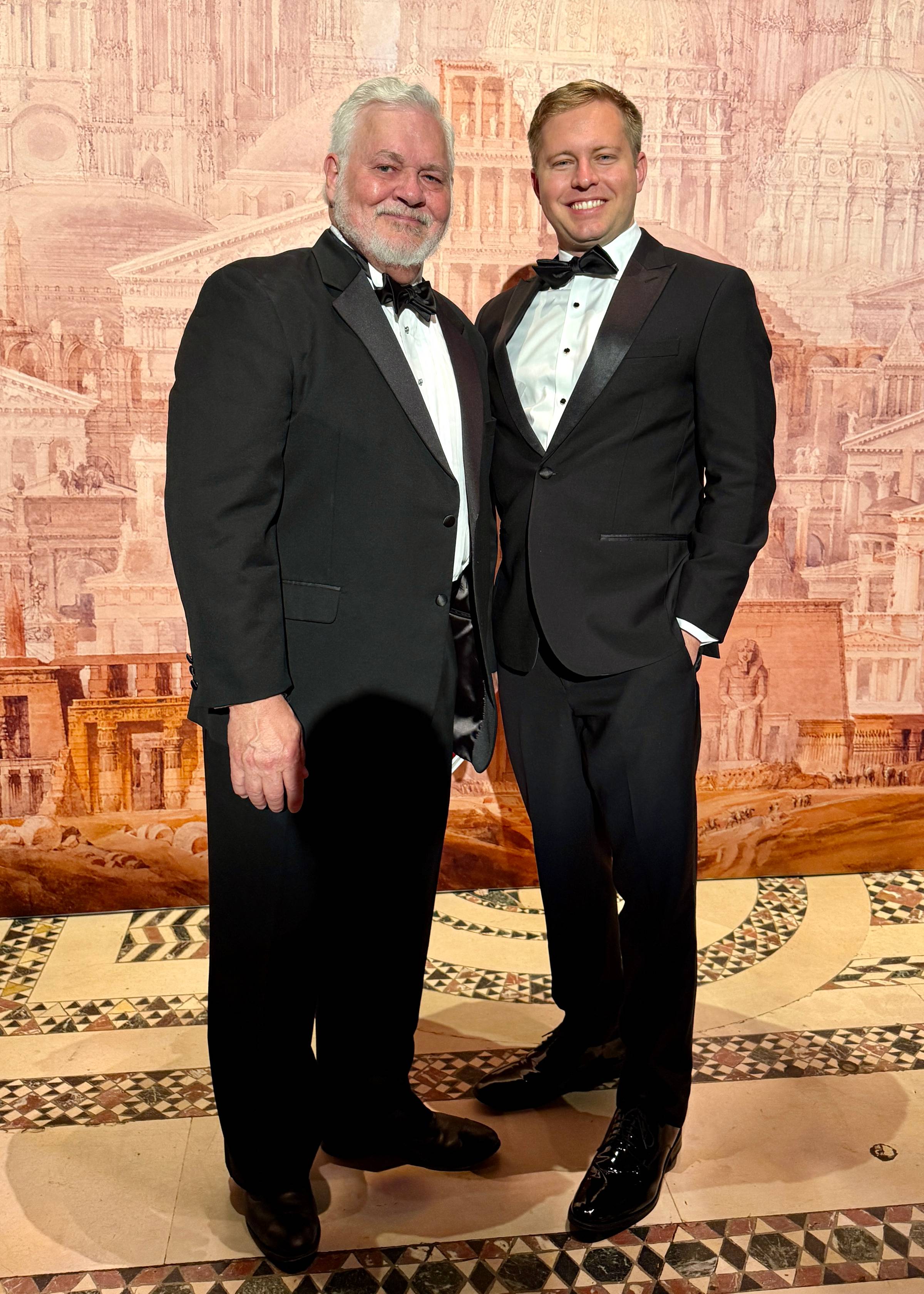 Kevin Harris in white tie with architect Henry Bien at the 45th Annual Arthur Ross Awards at Cipriani 42nd Street in New York, in front of a classical architectural backdrop.