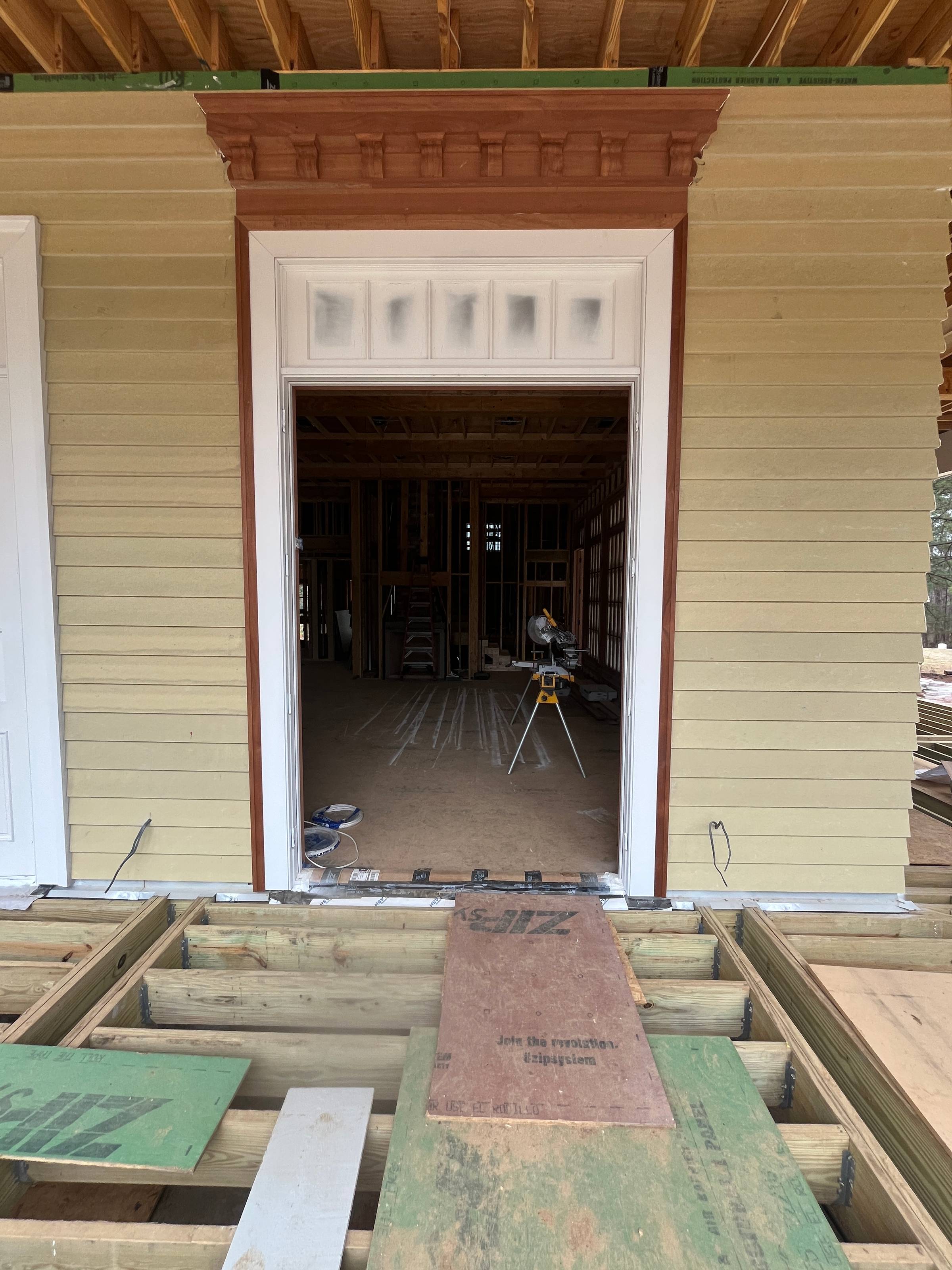 New construction in East Feliciana Parish showing 14-foot porch ceilings, Tuscan columns, and standing seam metal roof