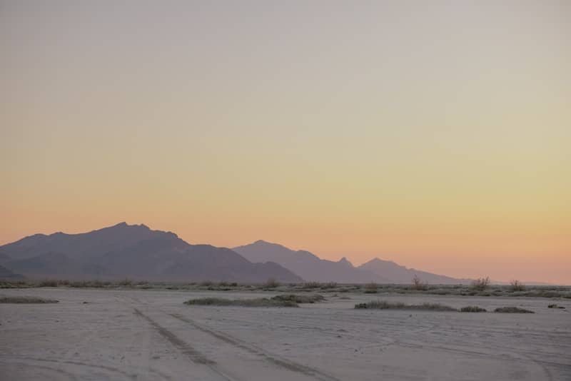 Soft sunset over distant mountains and flat terrain