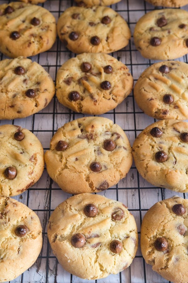 Chocolate chip cookies on a wire rack.