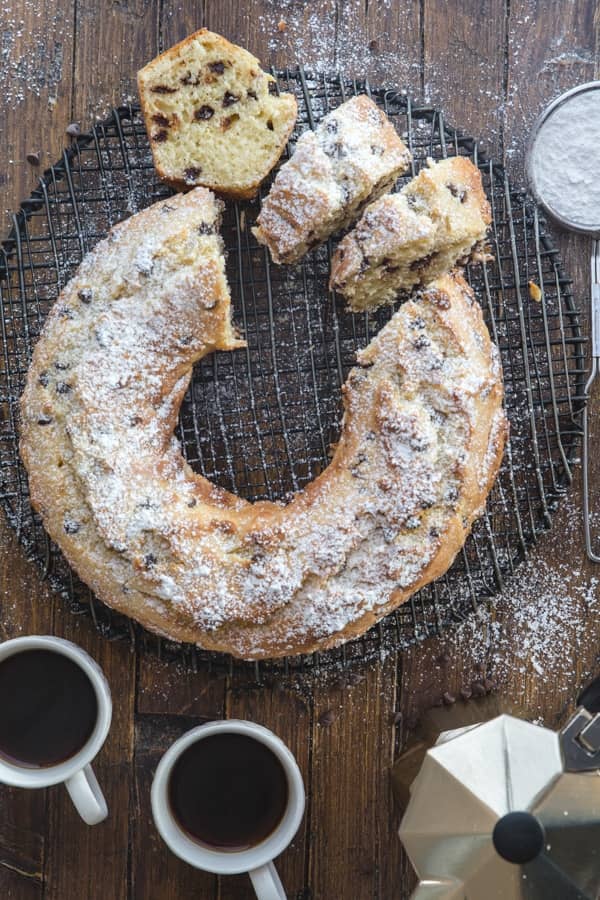 chocolate chip ricotta cake with three slices cut.