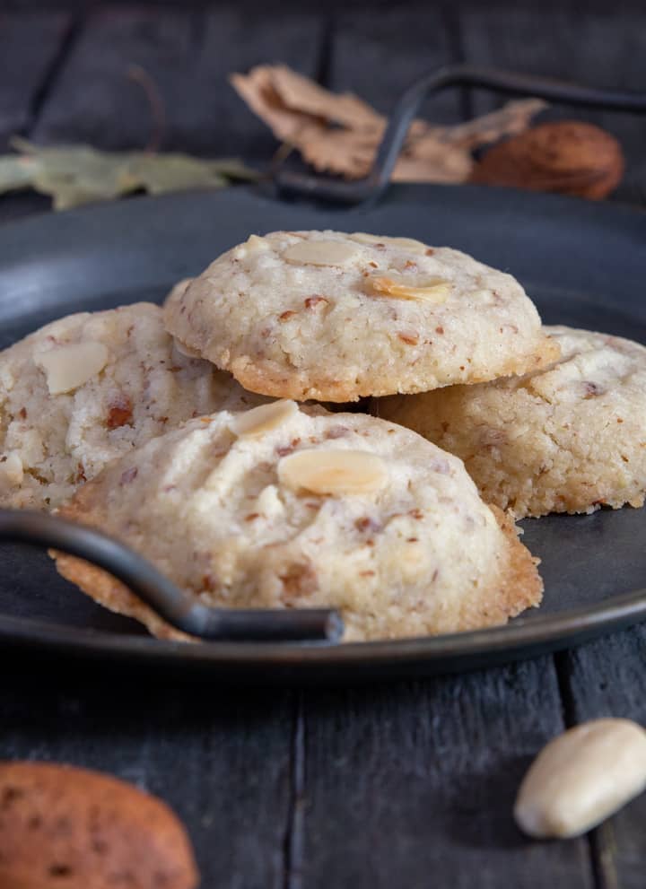 Almond butter cookies on a black plate. 