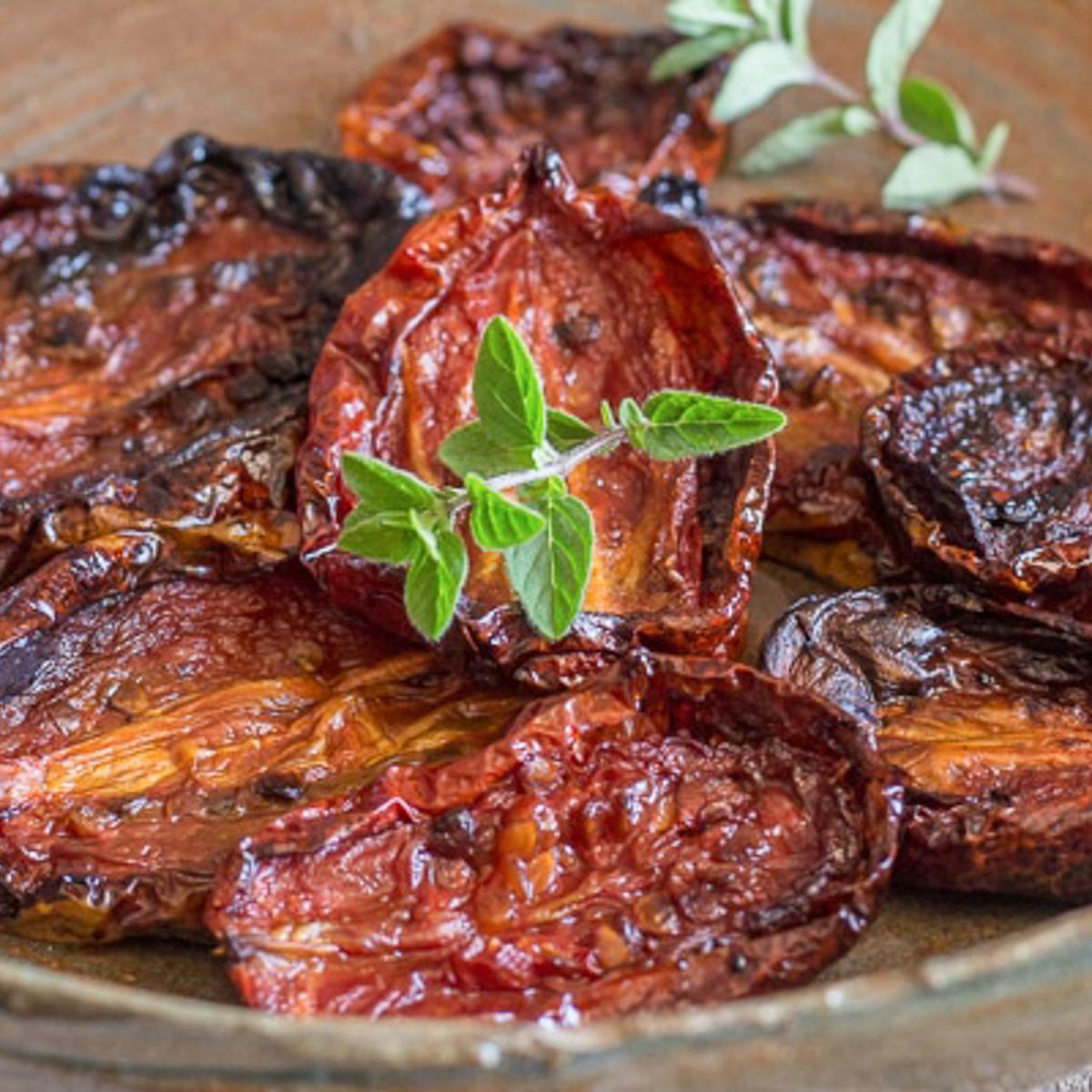 Sun dried tomatoes in a brown dish.