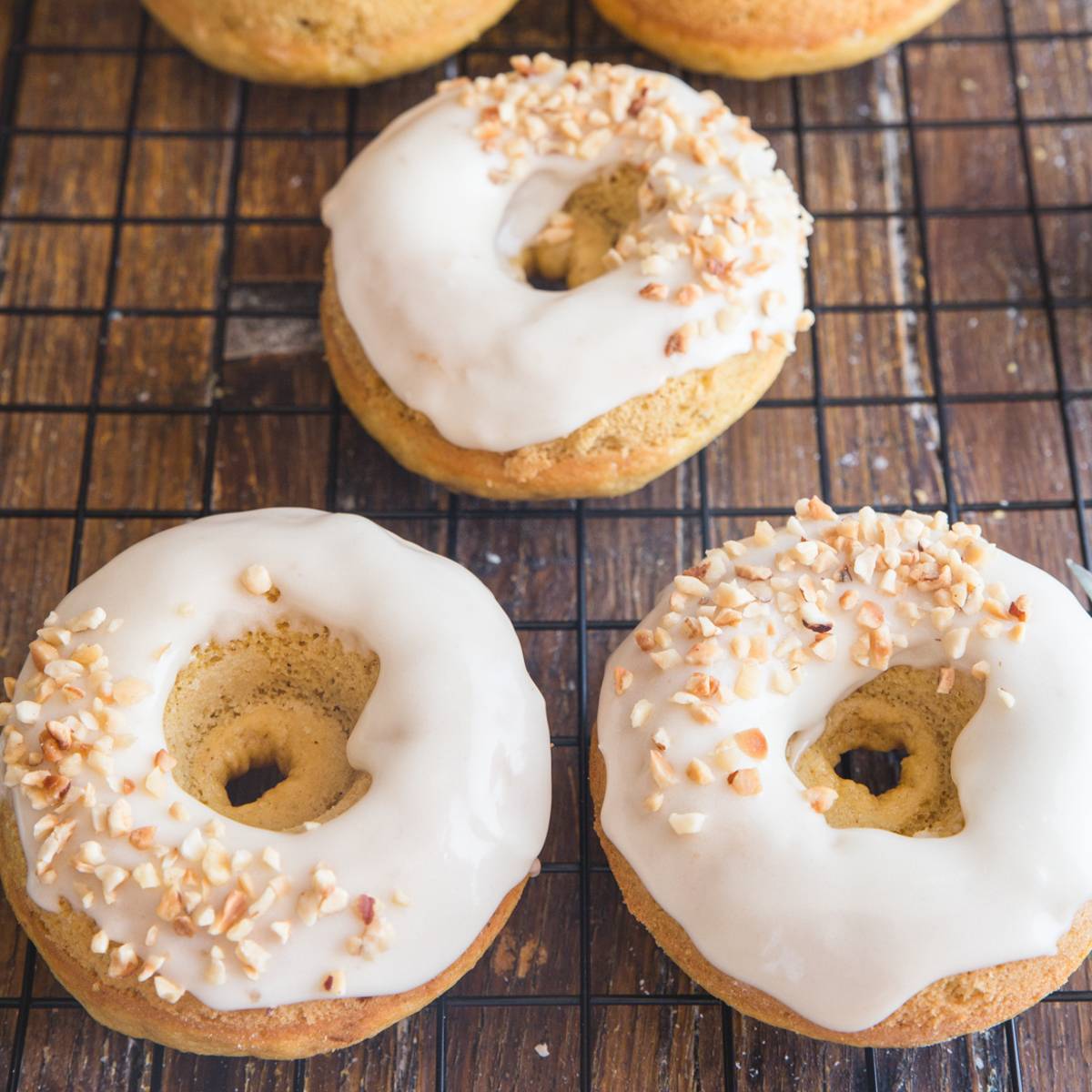 pumpkin donuts on a wire rack.