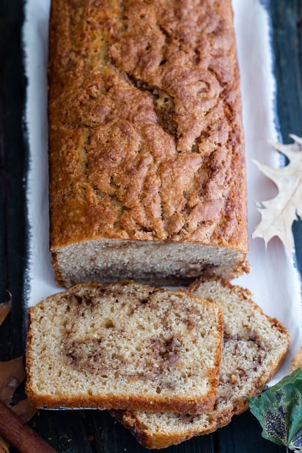 Easy swirled cinnamon bread on a white tray with two slices cut.