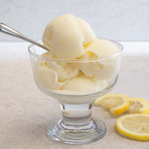 Lemon ice cream in a glass dish.