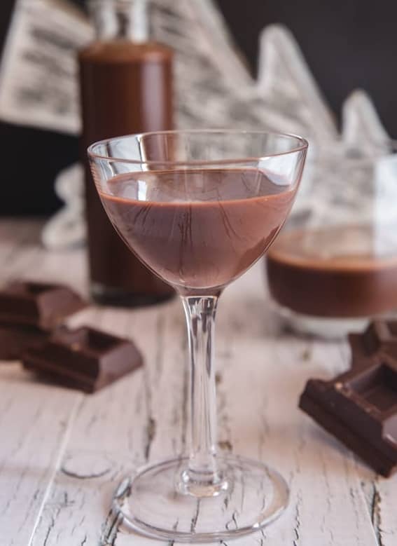 Chocolate liqueur in a bottle and two glasses.