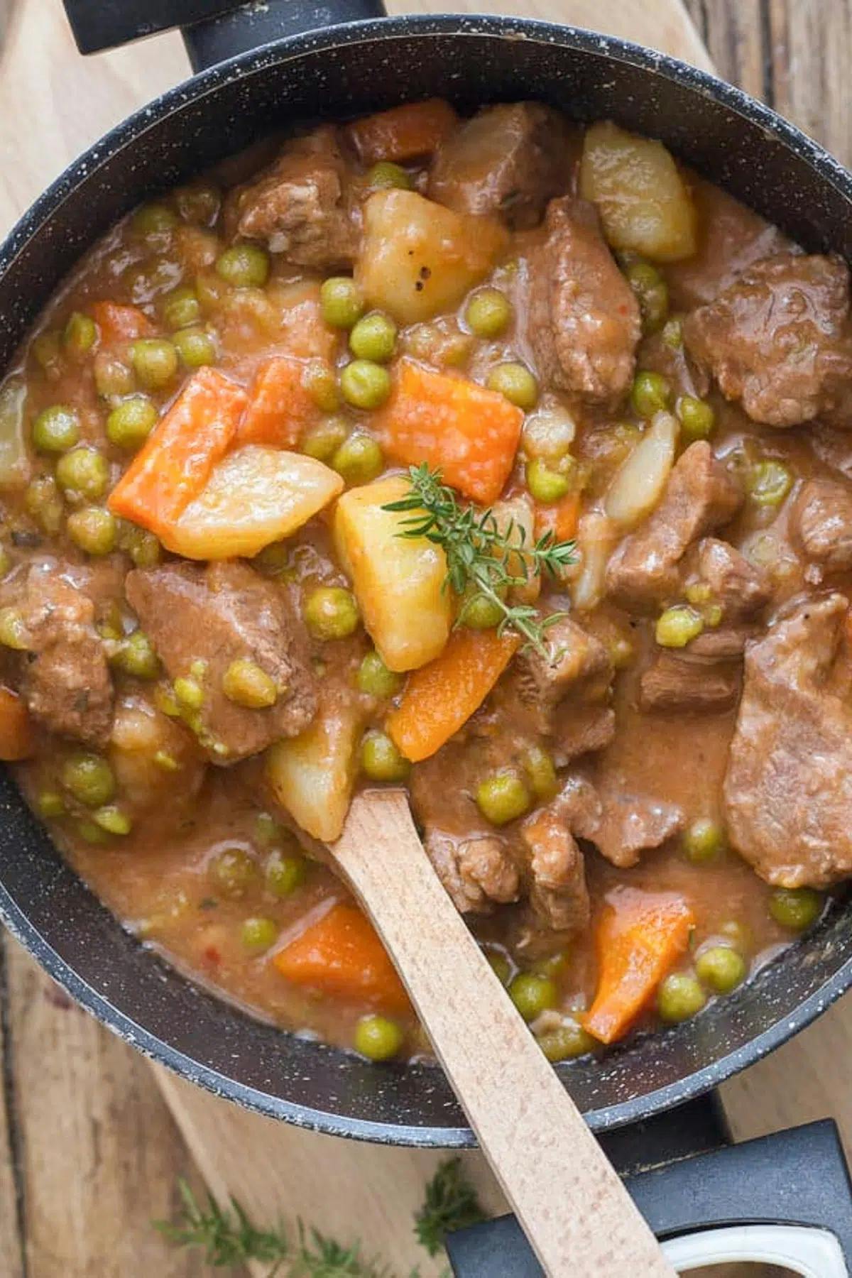 Thick Italian beef stew in a black pot.