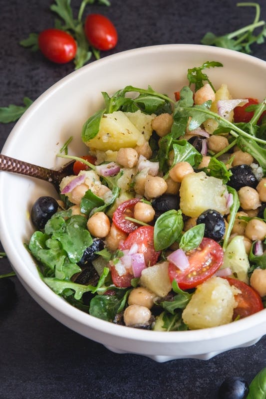 Chickpea salad in a white bowl.