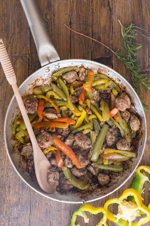 Sausage and peppers in a silver pan.