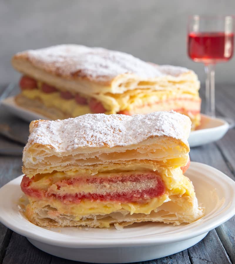 Italian Diplomatic Cake on a cake stand and a slice on a plate.