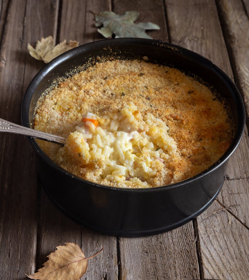 Leftover rice casserole in a black pan.