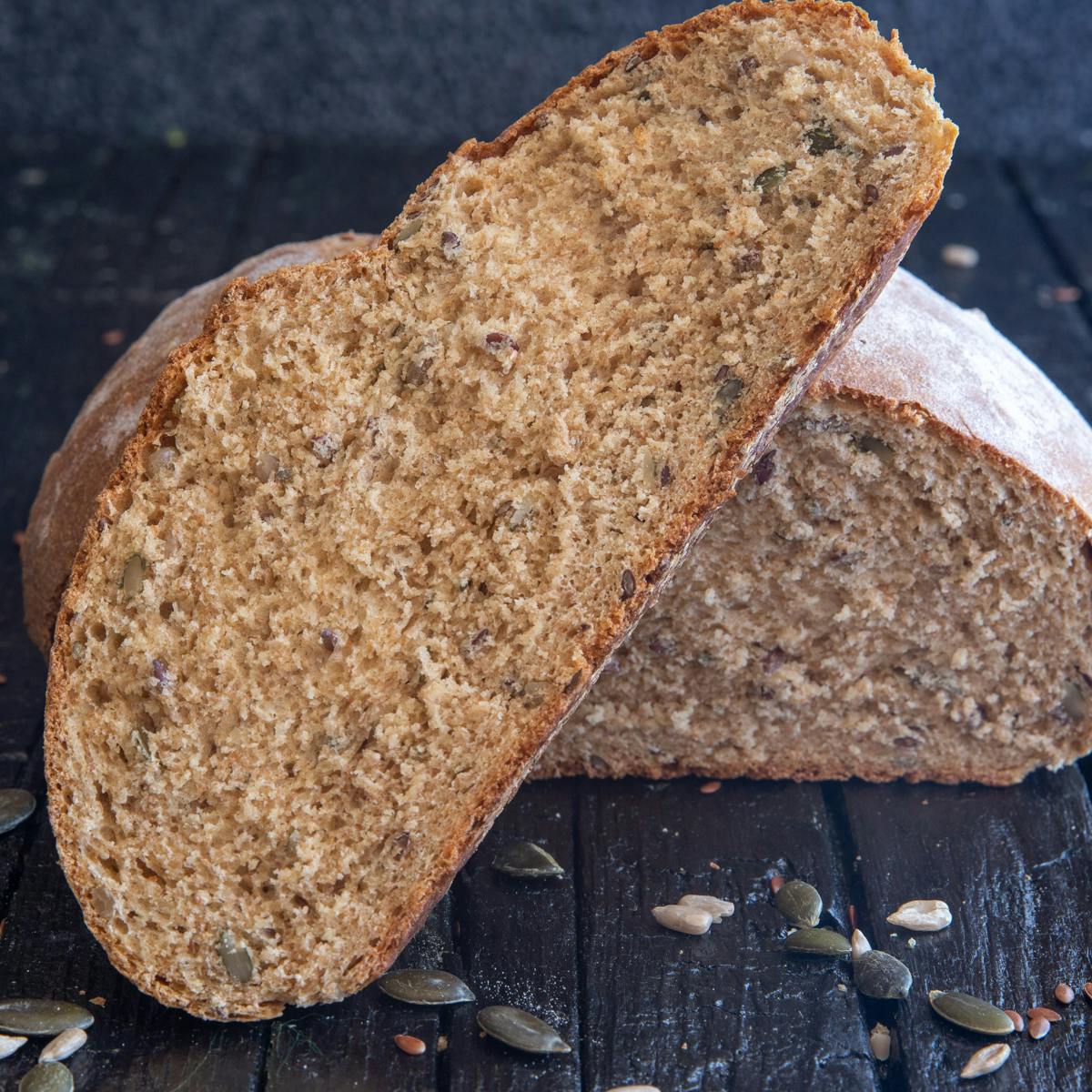 A slice of bread leaning against the loaf.