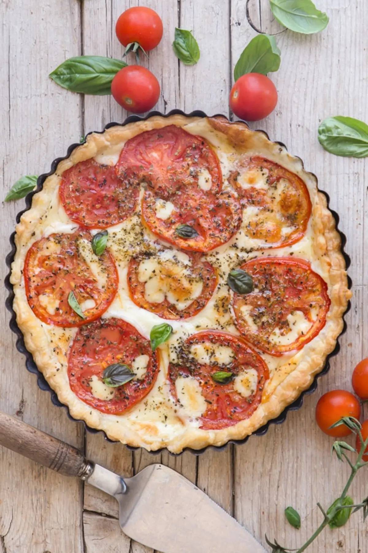 Easy Italian fresh tomato cheese pie on a wooden board.