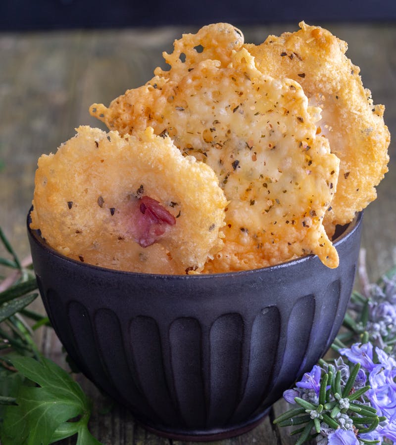 Cheese crisps in a black bowl.