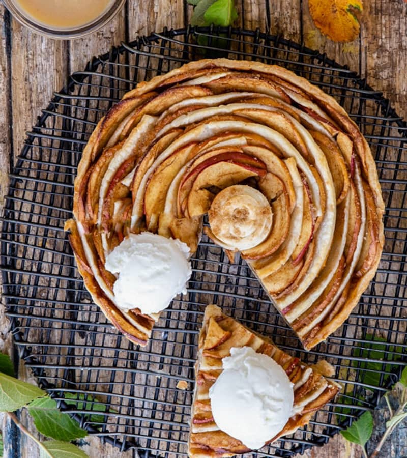 Puff pastry apple pie with a slice cut.