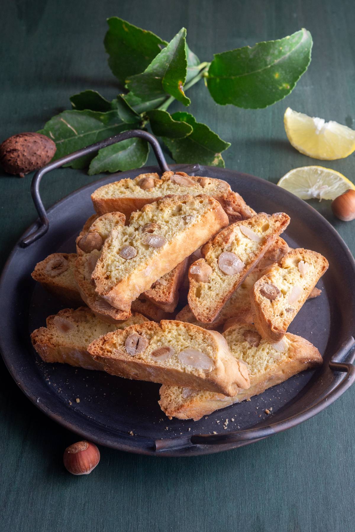 Lemon biscotti on a black plate.