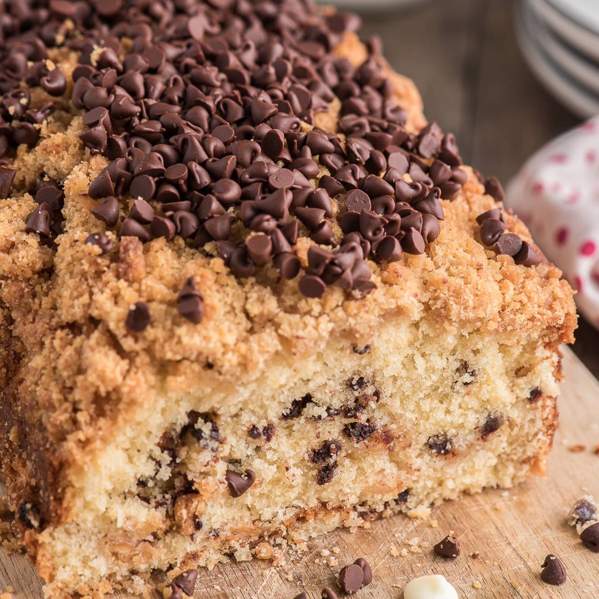 Chocolate chip crumb cake on a wooden board.